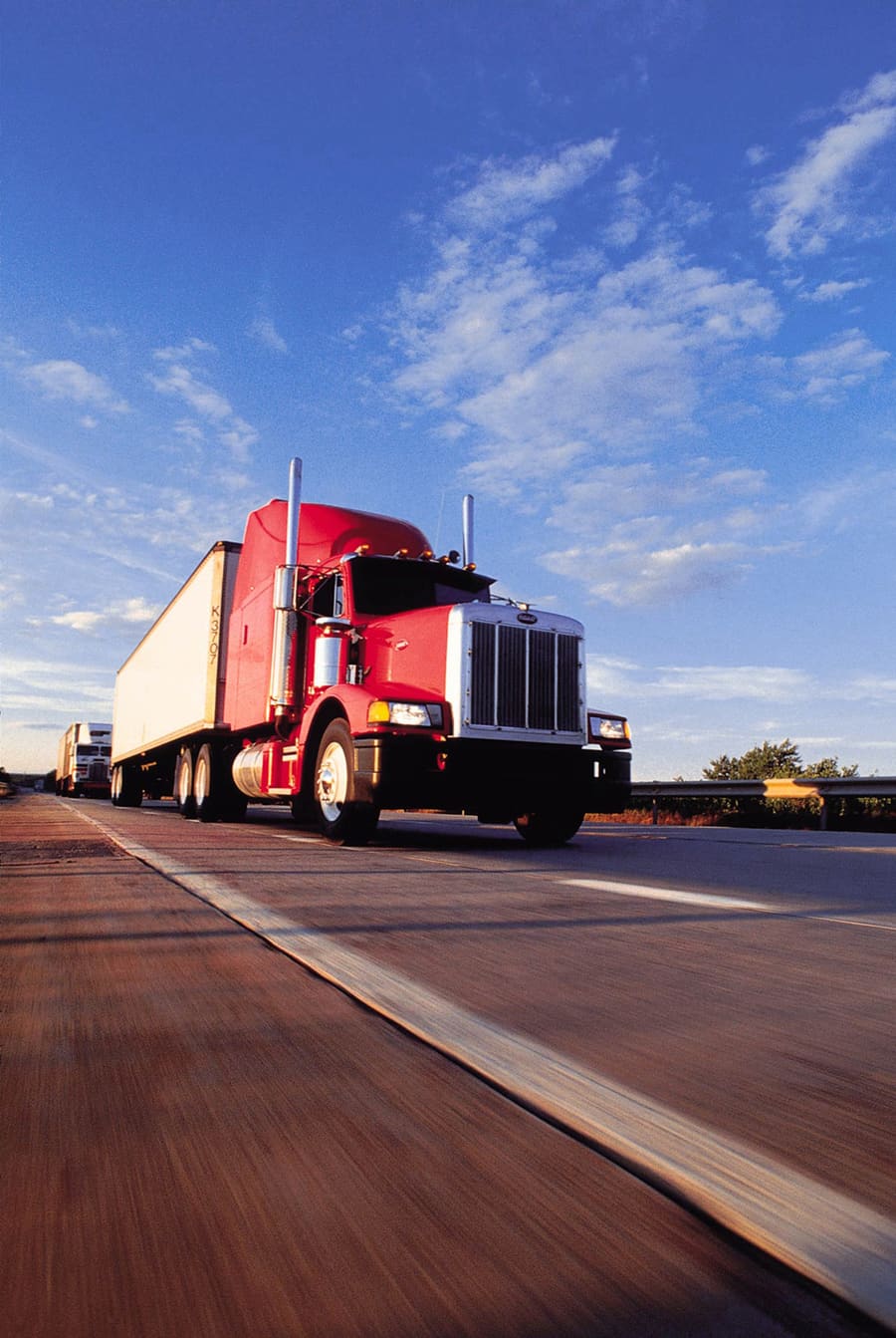 Red prime mover hauling a trailer